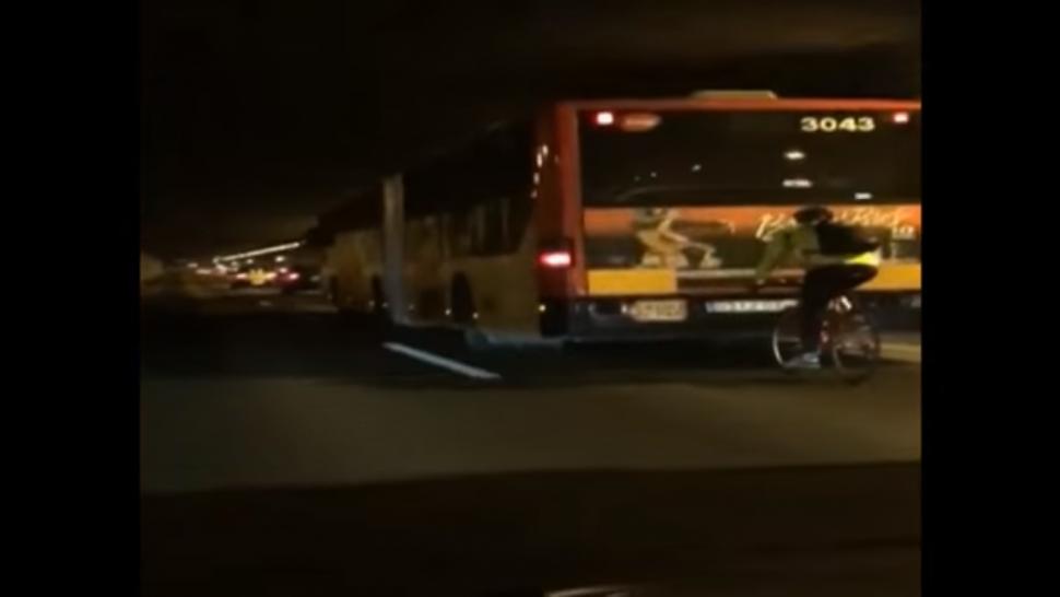 Barcelona cyclist slipstreams bus at 70kph on motorway