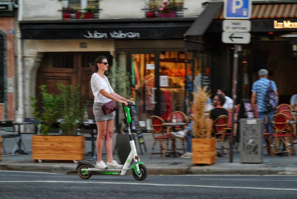 Lime e-scooter rider in Paris (copyright Simon MacMichael).jpeg