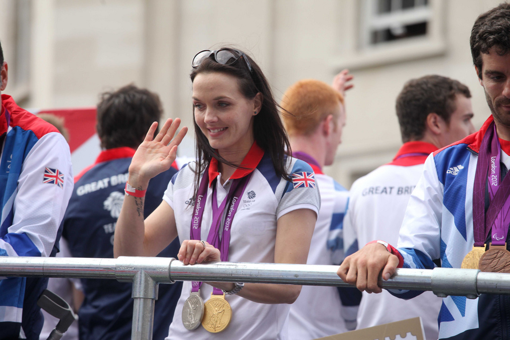 Victoria Pendleton waves from the Olympic parade bus